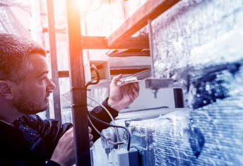 HVAC technician repairing AC unit